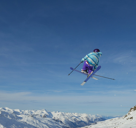 jumping skier at mountain winter snow fresh suny day