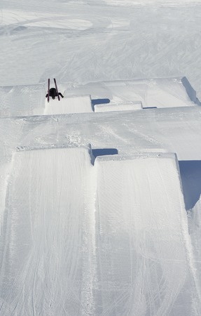 jumping skier at mountain winter snow fresh suny dayの写真素材