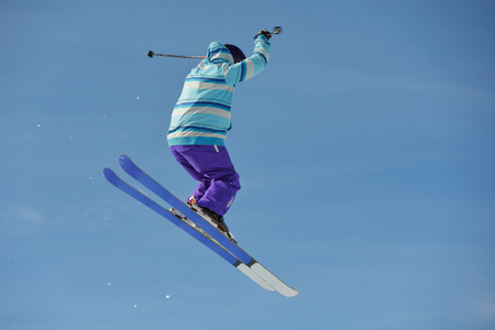 jumping skier at mountain winter snow fresh suny day