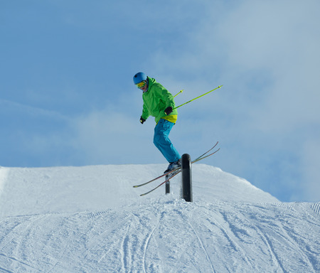 jumping skier at mountain winter snow fresh suny dayの写真素材