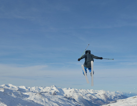 jumping skier at mountain winter snow fresh suny day