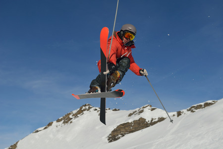 jumping skier at mountain winter snow fresh suny day