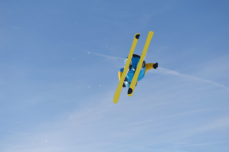 jumping skier at mountain winter snow fresh suny dayの写真素材