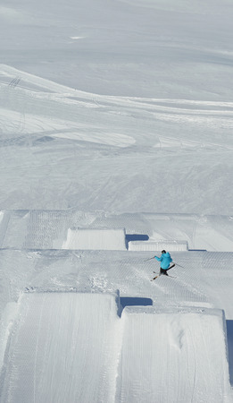 jumping skier at mountain winter snow fresh suny day
