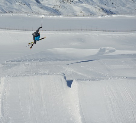 jumping skier at mountain winter snow fresh suny dayの写真素材