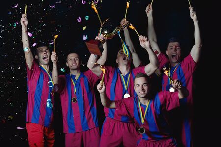 soccer players team group celebrating the victory and become champion of game while holding win coup