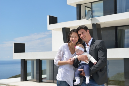 happy young family couple with beautiful new born baby have fun at homeの写真素材