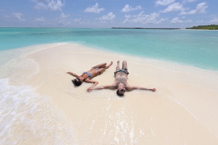 happy young romantic couple in love have fun and relaxing on beautiful beachの写真素材
