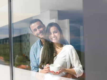 romantic happy young couple relax at modern home indoorsの写真素材