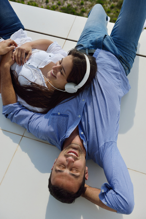 romantic happy young couple relax at modern home outdoorsの写真素材