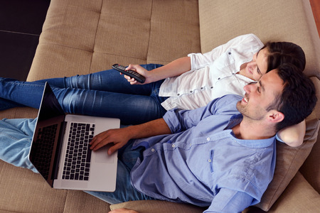 happy young relaxed  couple working on laptop computer at modern home indoorの写真素材