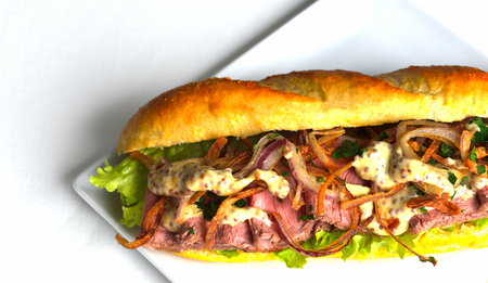 fresh sandwich close up with vegetables and meat fish isolated on white backgroundの写真素材