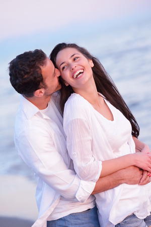 happy young romantic couple in love have fun on beautiful beach at beautiful summer dayの写真素材