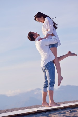 happy young romantic couple in love have fun on beautiful beach at beautiful summer dayの写真素材