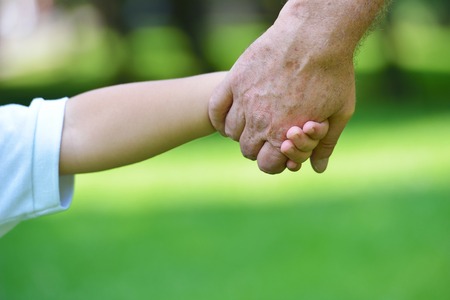 happy grandfather and child have fun and play in parkの写真素材