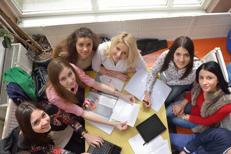 happy young teens group in school on chemisty lessons and library educationのeditorial素材