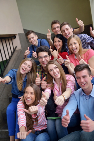happy young teens group in school have fun an learning lessonsの写真素材