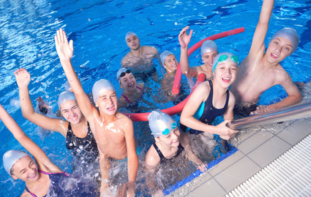 group of happy kids children   at swimming pool class  learning to swimの写真素材