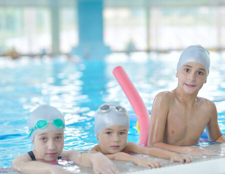 group of happy kids children   at swimming pool class  learning to swimの写真素材