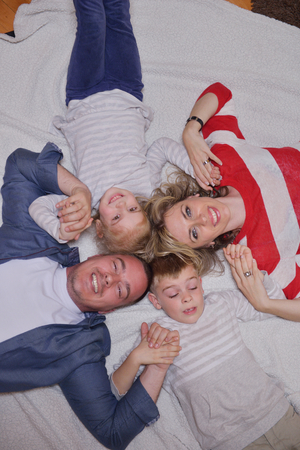 hapy young family have fun  with their children at modern living room home indoorsの写真素材