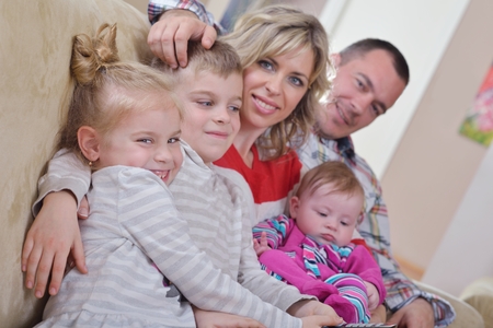 hapy young family have fun  with their children at modern living room home indoorsの写真素材