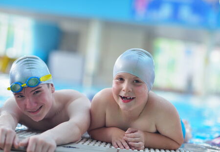 group of happy kids children   at swimming pool class  learning to swimの写真素材