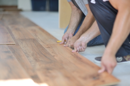 Installing laminate flooring in new home indoorの写真素材