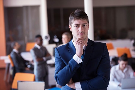 happy young business man portrait in bright modern office indoorの写真素材