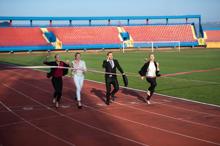 business people running together on racing trackの写真素材