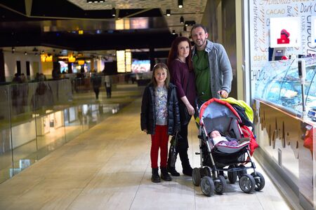 happy young family portrait in shopping mall