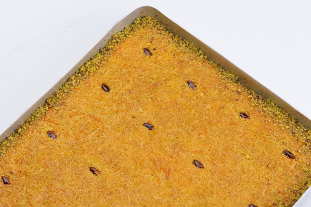 Turkish pastry kadaif close-up ,ready for syrup, background