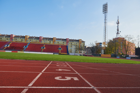 Red athletic track treadmill at the stadium with the numbering.