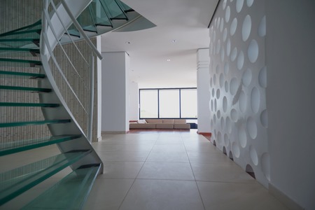 modern glass spiral staircase with metallic hand-rails.の写真素材