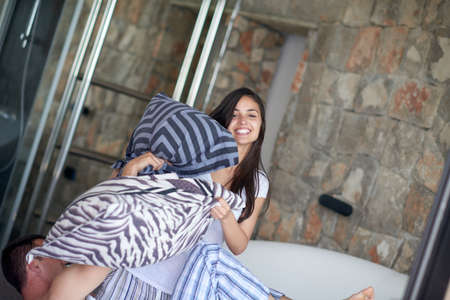 happy young couple relax and have fun in bedの写真素材