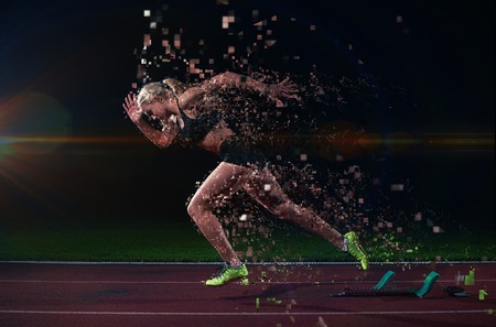 pixelated design of woman  sprinter leaving starting blocks on the athletic  track. Side view. exploding startの写真素材