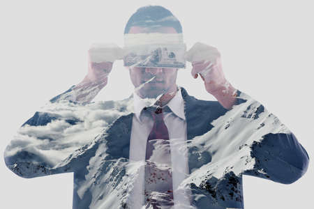 Portrait of a business man holding and catch falling money bills, isolated on white background in studioの写真素材