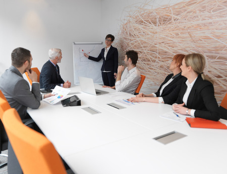 business people group on meeting at modern bright office indoors. Senior  businessman as leader in discussion.の写真素材