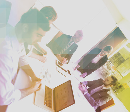 Double exposure with  low poly design. Business people group on meeting at modern bright office...