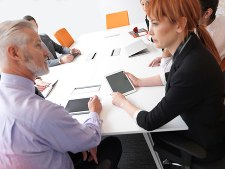 business people group on meeting at modern bright office indoors. Senior  businessman as leader in discussion.の写真素材