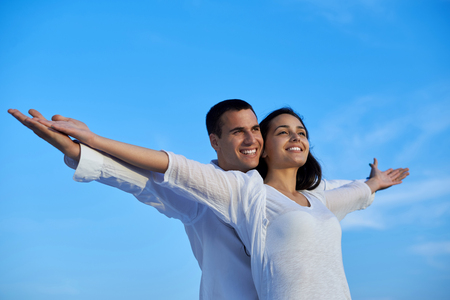 happy young romantic couple have fun relax smile at modern home outdoor terace balconyの写真素材