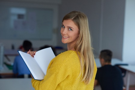 portrait of young female student at school classroom