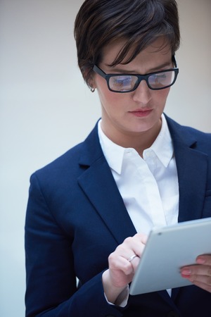 corporate business woman working on tablet computer  at modern office interiorの写真素材