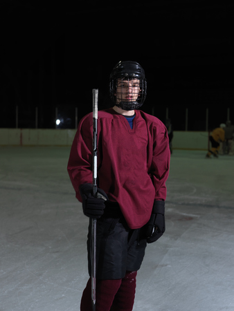 young ice hockey player portrait on training in black backgroundの写真素材