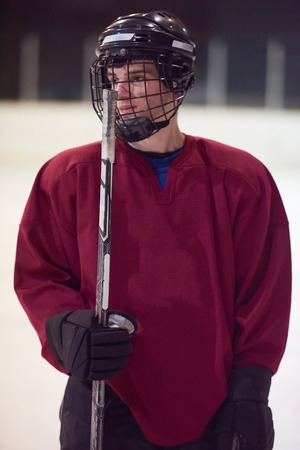 young ice hockey player portrait on training in black backgroundの写真素材