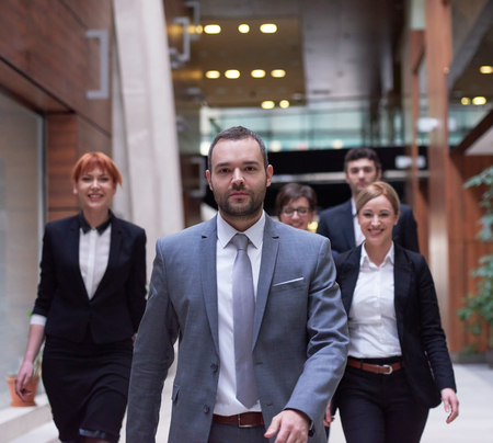 young business people team walking, group of people on modern office hall interiorの写真素材