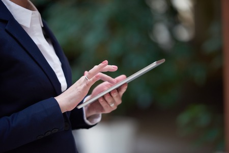corporate business woman working on tablet computer  at modern office interiorの写真素材