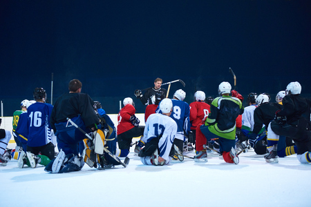 ice hockey players team group meeting with trainer  in sport arena indoorsの写真素材