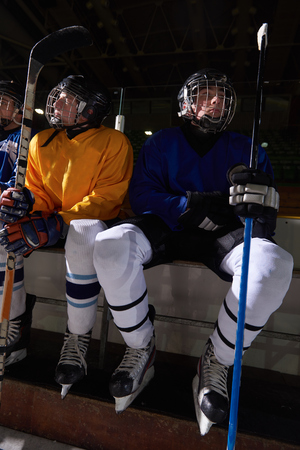 ice hockey players,  group of team friends waiting on bench to start  gameの写真素材