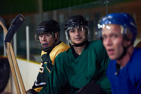 ice hockey players,  group of people,  team friends waiting and relaxing on bench to start  gameの写真素材