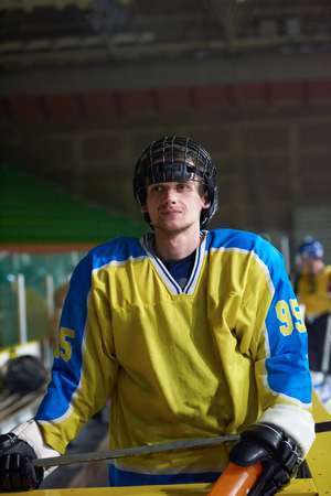 young ice hockey player portrait on training in black backgroundの写真素材